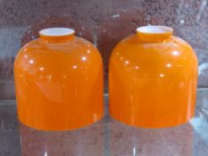 A pair of vintage overlaid glass lamp shades in white and orange, each 12.5cm dia.