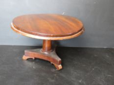 A miniature apprentice type tilt top occasional table having brass fitting and triform base,