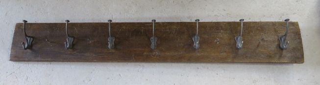 A wall hanging coat rack having seven vintage style hooks upon measuring approx 123cm wide.