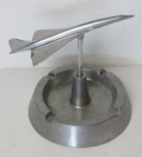 Concorde memorabilia; an aluminium smoker's receptacle having model Concorde above, approx 17cm dia.