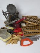 A manual printing press by Adana Five-Three together with a large quantity of type setting blocks