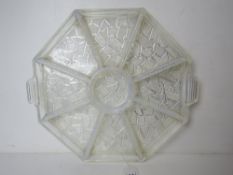 A milk glass hors d'ouvres tray having nine segments and measuring 34cm wide.
