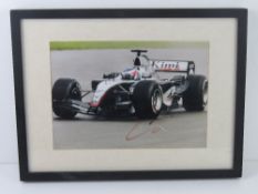 A hand signed photograph of Kimi Raikkonen, framed.