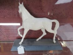 A Beswick horse in matt white on black base approx 27.5cm wide.