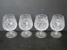 A set of four Stuart Crystal brandy glasses.