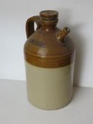 A salt glazed stoneware jug with stopper and spout marked 'Domestos' approx 35cm high.