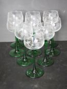 A set of nine green stemmed floral pattern hock glasses.