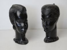 A pair of African carved heads being male and female, each approx 17cm high.