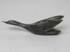 An Inuit green soapstone carving of a bird taking flight,