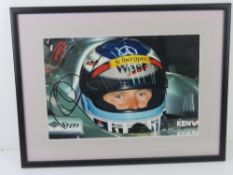 A hand signed photograph of Mika Hakkinen, framed.