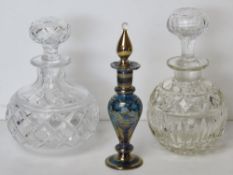 Two cut glass perfume bottles, each with stopper, together with Venetian style glass perfume bottle.