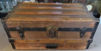 A canvas covered wooden and metal banded Navy type trunk measuring approx 69cm wide.