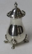 A HM silver pepperette raised over four pad feet, hallmarked for London 1922, standing 9cm high, 47.