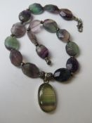 A hardstone necklace with pendant having white metal fittings stamped 925 having green and purple