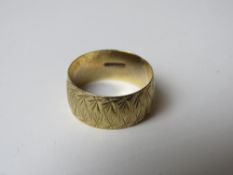 A 9ct gold ring, the wide band having engraved pattern throughout and hallmarked 375, size N, 2.7g.