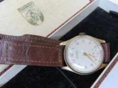 A 9ct gold Buren Grand Prix wrist watch on original strap with original presentation box having