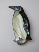 An abalone shell and mother of pearl penguin brooch in box for Carole Holding Studios Bermuda.