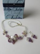 A contemporary beaded necklace and earring having floral and grape design in Oliver Weber