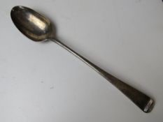 A HM silver serving spoon (hallmark almost erased) having shield engraving to terminal,
