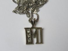 A 10ct white gold pendant and chain 'M' stamped 10k throughout, 2.1g.