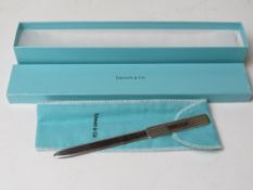 A Tiffiny & Co HM silver letter opener having London Import hallmark and complete with box, 33.9g.