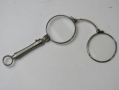 A pair of white metal lorgnettes having sprung loaded clasp.