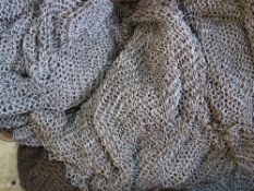 A chain mail suit of under armour, with top, trousers, hood and glove.