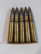 A quantity of WWII Boyz anti tank rifle inert rounds on clip, rounds and clip are dated 1943.
