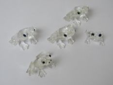Four Swarovski crystal frog figurines, together with another similar, largest approx 3.5cm wide.
