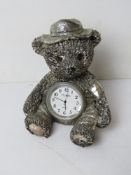 A silver plated Teddy bear having clock to stomach marked WM Widdop, standing approx 9cm high.