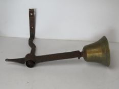 An antique wall mounted brass bell marke