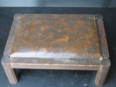 A small wooden and leatherette footstool