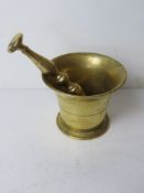 A brass pestle & mortar approx 12cm dia.