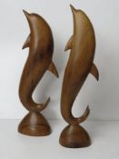 A pair of carved wooden dolphin figurine