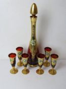 A gilded and hand painted Venetian glass decanter with six glasses.