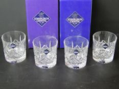 A set of four Edinburgh Crystal whiskey glasses with original packaging.