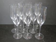 A set of nine champagne flutes.