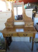 A pine dressing table having twin drawer