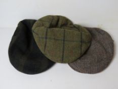 A Carey Gunmakers Ltd 100% wool cap together with a Hucklecote 100% cap, and another similar.