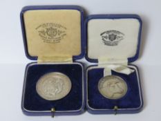 Two HM silver agricultural prize medals in fitted presentation boxes.