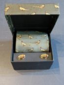 A gift set tie and cuff links having phe