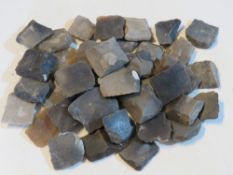 Approx forty antique brown bess flints.