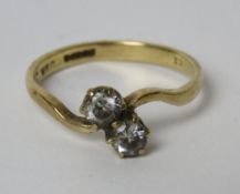 A 9ct gold ring set with two white stones, size O, 2.2g.