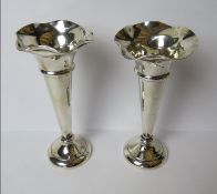 A pair of HM silver bud vases having fluted rims and weighted bases,