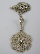 A continental silver floral filigree pendant, stamped 935 and measuring 2.