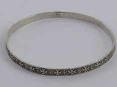 A silver bangle having Maltese cross pattern throughout and Maltese hallmark upon, 6.