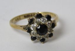 A 9ct gold sapphire and white stone floral cluster ring, hallmarked 375, size N, 2.3g.