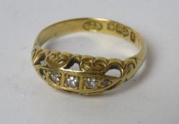 An 18ct gold diamond Gypsy ring having carved head and Chester hallmark, size M, 2.3g.
