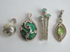 A white metal and marcasite pendant together with three other pendants stamped 925. Four items.