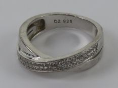 A contemporary silver ring set with cz stones, stamped 925, size N.